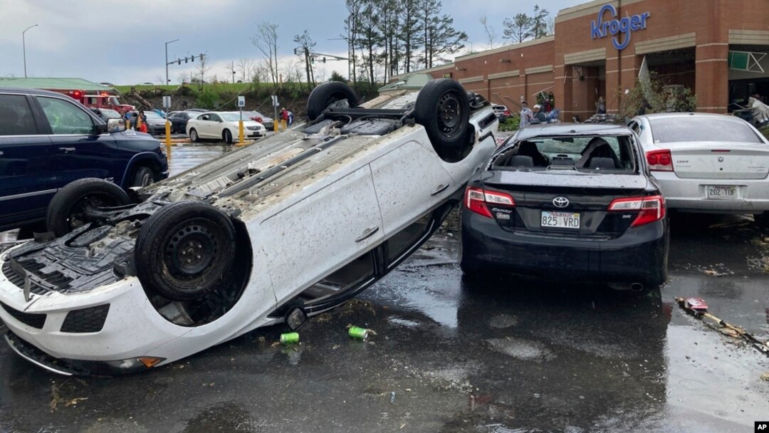 A car is upturned in a Kroger parking lot after a severe storm swept through Little Rock, Ark., March 31, 2023.