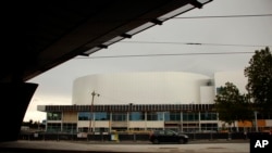 A car drives past the future Olympic venue "Porte de la Chapelle Arena" in Paris, July 23, 2023. 