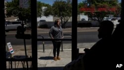 Adelita Valentine, owner of HairFreek Barbers, stands for a photo outside her barbershop in Los Angeles, Aug. 21, 2024.