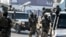 FILE - Afghan security personnel arrive at the Kabul airport in Kabul, Feb. 12, 2024. The Taliban government confirmed, March 31, 2024, they had detained 'a number of foreign citizens, including two Americans' for allegedly violating their laws. 