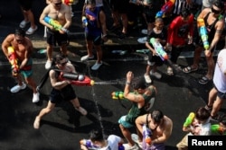Locals and tourists celebrate Songkran, marking the Thai New Year, in Bangkok, Thailand, April 13, 2024.