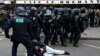 French riot police apprehend a protester amid clashes during a demonstration as part of nationwide strikes and protests against French government's pension reform, in Paris, March 23, 2023.