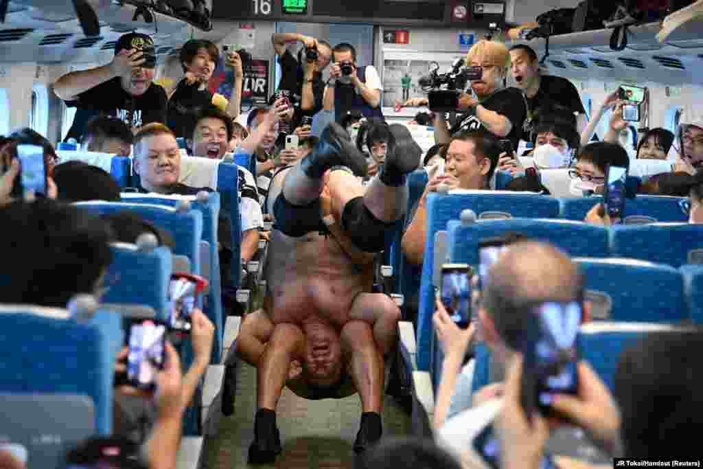 Minoru Suzuki and Sanshiro Takagi, wrestlers from Japanese professional wrestling promotion DDT Pro-Wrestling, fight inside Tokaido Shinkansen bullet train from Tokyo to Nagoya during a wrestling show, Sept. 18, 2023.