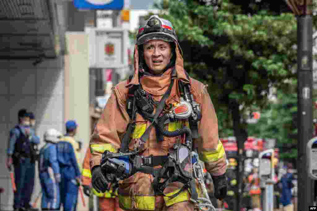 A firefighter works outside of a building where an explosion and a fire broke out in Shimbashi area of Tokyo, Japan.&nbsp;Four people were injured and&nbsp;officials are investigating the cause of the fire.