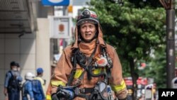 A firefighter works outside of a building where an explosion and a fire broke out in Shimbashi area of Tokyo, Japan.&nbsp;Four people were injured and&nbsp;officials are investigating the cause of the fire.