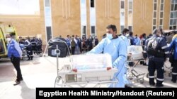 Medics transfer premature Palestinian babies evacuated from Gaza to ambulances on the Egyptian side of the Rafah border, Nov. 20, 2023.
