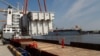 FILE - An autotransformer intended for the expansion of the Lithuanian-Polish electricity system connection LitPol Link is loaded on a barge in the port of Klaipeda, Lithuania, May 13, 2021.