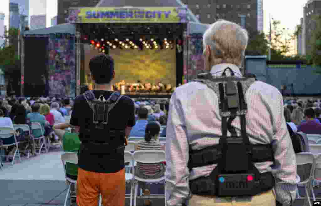 Concertgoers wear haptic suits created for the deaf by Music: Not Impossible, during an outdoor concert at Lincoln Center in New York City. Vests feature 24 points of vibration to translate the music onstage. Audio expert Patrick Hanlon programs wireless haptic suits designed to enable the deaf or hard of hearing to experience orchestral music as initiatives to improve inclusivity at live music performances break new ground.&nbsp;