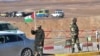 Un drapeau du Sahara occidental flotte à un poste de contrôle tenu par des membres des forces de sécurité sahraouies à l'extérieur du camp de réfugiés de Dakhla.