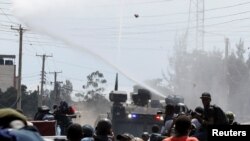 FILE - Riot police use water cannons as they clash with supporters of Kenya's opposition leader Raila Odinga during a nationwide protest over cost of living and President William Ruto's government in Kawangware neighborhood of Nairobi, Kenya March 27, 2023. 