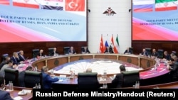 Negotiators and officials attend a meeting of defense ministers of Russia, Iran, Syria and Turkey in Moscow, Russia, April 25, 2023. 