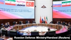 FILE - Negotiators and officials attend a meeting of defense ministers of Russia, Iran, Syria and Turkey in Moscow, Russia, April 25, 2023. The foreign ministers of Turkey and Syria are set to meet May 10, 2023, in Moscow.