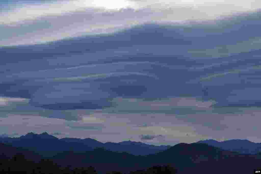 Lenticular clouds are seen above Corsican mountains in Cognocoli-Monticchi on the French Mediterranean island of Corsica.