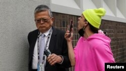 A protester taunts an attendee of the Asia-Pacific Economic Cooperation (APEC) CEO Summit during a rally in opposition to the summit in San Francisco, California.