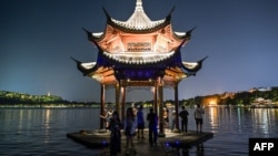 People gather at the West Lake in Hangzhou, China's eastern Zhejiang province, Sept. 18, 2023, ahead of the 19th Asian Games to be held in the city from Sept. 23 till Oct. 8.