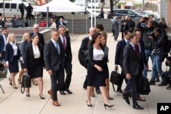 Representatives of Dominion Voting Systems arrive at the justice center in Wilmington, Delaware, for the Dominion Voting Systems' defamation lawsuit against Fox News, April 18, 2023.