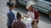 FILE - A vendor sells mobile phone credit cards on a street in Addis Ababa, Ethiopia, Nov. 3, 2022. Ethiopia, which had imposed internet shutdowns because of ethnic unrest in the country, recently lifted its restrictions.