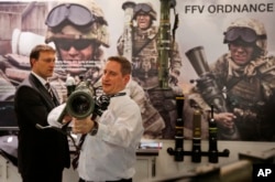 FILE - An exhibitor of SAAB, a Swedish defense company, shows the 85MM Carl-Gustaf, a portable artillery system during the 8th International Land and Naval Defense system exhibition, in New Delhi, India, Feb. 6, 2014.