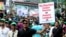 A BNP activist holds a poster at a Dhaka, Bangladesh, protest rally July 12, 2023, saying that the party does not want the next general election to be held while the Awami League and Sheikh Hasina are in power. (Babul Talukdar for VOA)