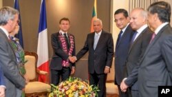 This photo released by Sri Lanka President's office shows Sri Lankan President Ranil Wickermesinghe shakes hands with his French counterpart, Emmanuel Macron, in Colombo, Sri Lanka, July 28, 2023. 