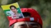 A Myanmar protester residing in Japan uses a flag with an image of deposed Myanmar leader Aung San Suu Kyi during a rally to mark the second anniversary of Myanmar's 2021 military coup, outside the Embassy of Myanmar in Tokyo on February 1, 2023. (Issei Kato/Reuters)