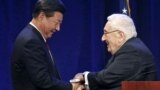 FILE - Chinese President Xi Jinping, left, shakes hands with former U.S. National Security Adviser and Secretary of State Henry Kissinger in Seattle, Washington, Sept. 22, 2015.