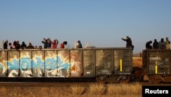 Migrants ride on a train towards Ciudad Juarez, in La Escuadra, Chihuahua, Mexico. March 28, 2023.
