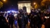 Police officers patrol in front of the Arc de Triomphe on the Champs Elysees in Paris, July 1, 2023.