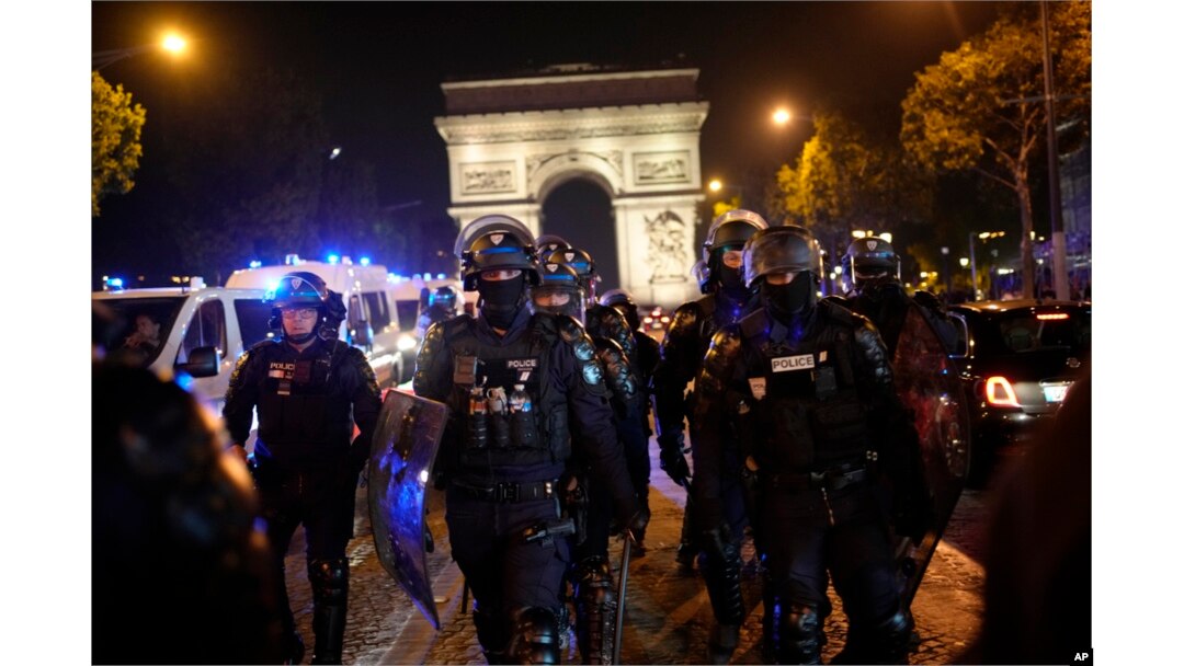 Police officers patrol in front of the Arc de Triomphe on the Champs Elysees in Paris, July 1, 2023.