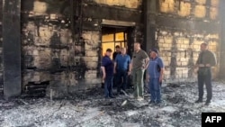 In this grab taken from a handout footage on June 24, 2024, Dagestan region governor Sergei Melikov visits a burned out synagogue, which was attacked by gunmen, in Derbent. (AFP photo / administration of the head of Russia's Dagestan Republic) 