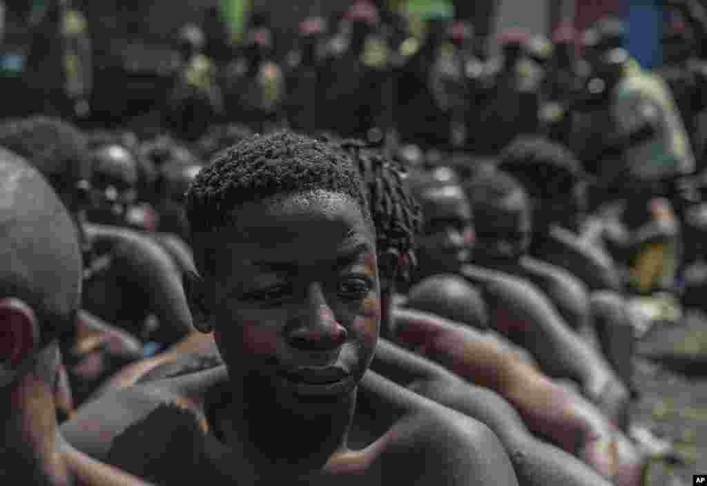 Arrested members of the Wazalendo sect are sat and lined up in Goma, Democratic Republic of the Congo, Wednesday, August 30, 2023. More than 40 people died and dozens were injured in clashes in the Congolese city of Goma between protesters from the Wazalendo religious sect and the armed forces, national authorities said.