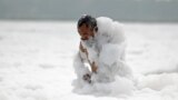 A man bathes in the polluted waters of river Yamuna laden with foam, on the eve of world environment day in New Delhi, India, June 4, 2023. 