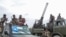 FILE - Somali military force members supporting anti-government opposition leaders gather before leaving to their bases in Mogadishu, Somalia, on May 7, 2021
