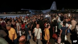 Jordanians evacuated from Sudan arrive at a military airport in Amman, Jordan, April 24, 2023.