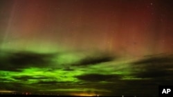 FILE - An aurora borealis, also known as the northern lights, is seen in the night sky April 24, 2023, near Washtucna, Wash. 