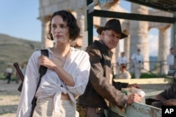 This image released by Lucasfilm shows Phoebe Waller-Bridge, left, and Harrison Ford in a scene from "Indiana Jones and the Dial of Destiny."