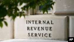 FILE - A sign outside the Internal Revenue Service building is seen, May 4, 2021, in Washington. 