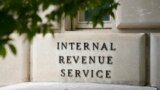 FILE - A sign outside the Internal Revenue Service building is seen, May 4, 2021, in Washington. 