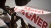 FILE - Protesters holds a banner reading "Thank you Wagner," the Russian paramilitary group, during a demonstration organized by the pan-Africanist platform Yerewolo to celebrate France's announcement to withdraw French troops from Mali, in Bamako, on February 19, 2022.