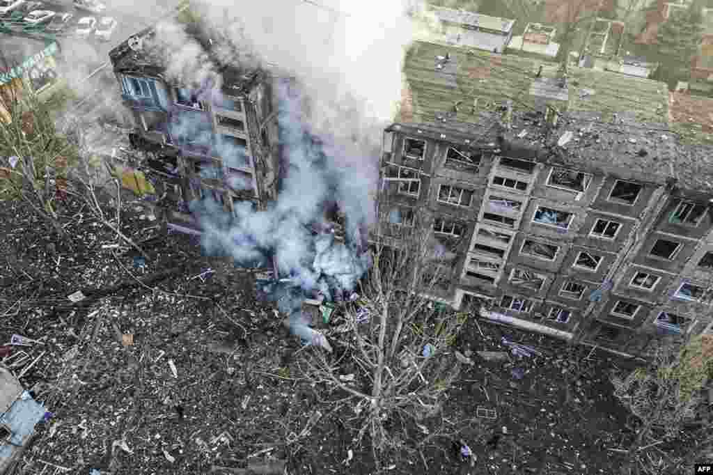This handout photograph taken and released by National Police of Ukraine shows rescuers extinguish a fire in a residential building following a missile attack in Selydove, Donetsk region.&nbsp;