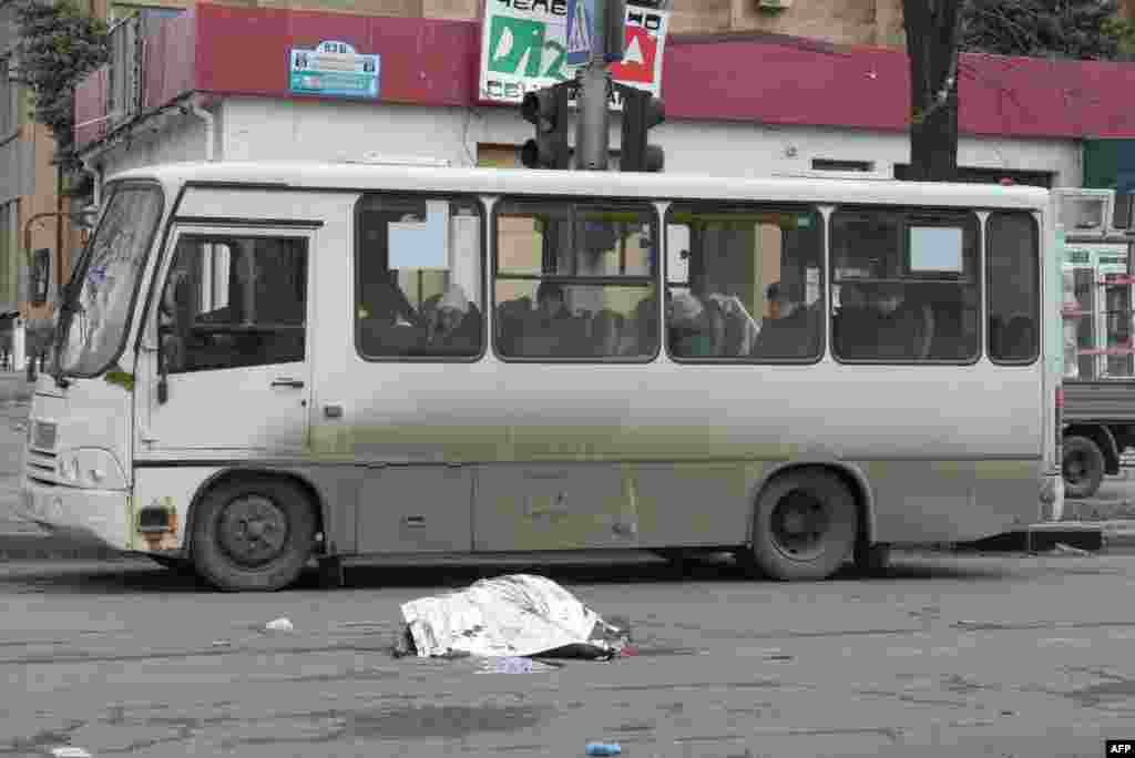 The body of a woman killed in recent shelling lies on a street in Donetsk, Russian-controlled Ukraine amid the Russia-Ukraine conflict.