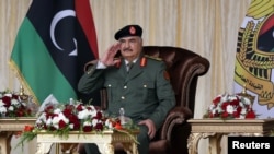 FILE- Libyan military commander Khalifa Haftar gestures during Independence Day celebrations in Benghazi, Libya December 24, 2020. 
