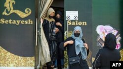 Afghan women stage a protest for their rights at a beauty salon in the Shahr-e-Naw area of Kabul on July 19, 2023. 