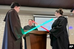 FILE - Julia and Robert Jones exchange vows during their "Star Wars" themed wedding in Akron, Ohio, on May 4, 2023. (AP Photo/Patrick Orsagos, File)