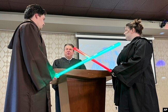 FILE - Julia and Robert Jones exchange vows during their "Star Wars" themed wedding in Akron, Ohio, on May 4, 2023. (AP Photo/Patrick Orsagos, File)