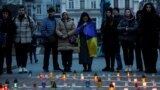 (FILE) People attend a commemorative rally for people killed by Russian air strike in Kyiv, Ukraine.