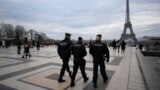 French gendarmes patrol the Trocadero plaza near the Eiffel Tower after a man targeted passersbys late Saturday, killing a German tourist with a knife and injuring two others in Paris, Dec. 3, 2023.