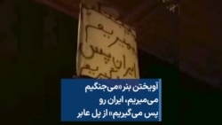 آویختن بنر «می‌جنگیم،‌ می‌میریم، ایران رو پس می‌گیریم» از پل عابر