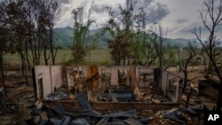 FILE - The shell of a burnt house stands following ethnic clashes and rioting in Sugnu, in the Indian state of Manipur, June 21, 2023. Manipur has been reeling under a spree of killings and arson after Christian Kukis and mostly Hindu Meiteis began clashing in May.