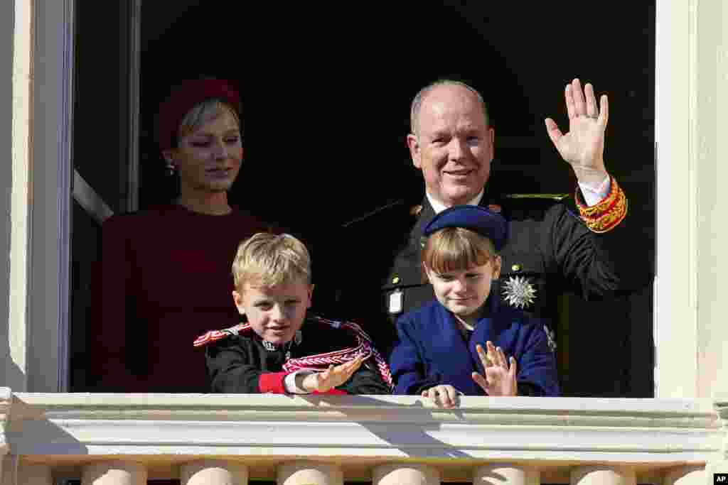 Prince Albert II of Monaco and Princess Charlene wave with their children Prince Jacques and Princess Gabriella from the balcony of the Monaco Palace during ceremonies marking National Day in Monaco.